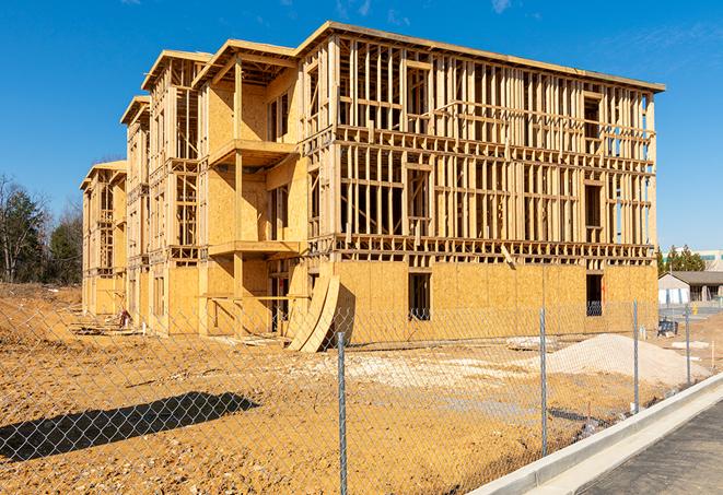 a close-up of temporary chain link fences enclosing a construction site, signaling progress in the project's development in Clarence Center